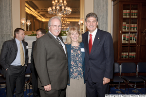 ["Senator Joe Manchin stands with two supporters after his Senate Swearing-In Ceremony."]%