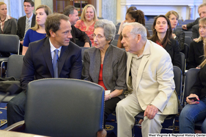 ["Mike Rowe, a television personality, sits beside his parents at Senate Commerce Committee hearing."]%