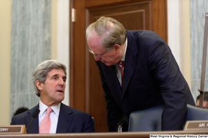 ["Senator John D. (Jay) Rockefeller speaks with Senator Kerry before a Commerce Committee hearing."]%