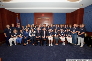 ["Senators John D. (Jay) Rockefeller and Joe Manchin sit for a photograph with an unidentified women's organization."]%