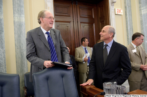 ["Senator John D. (Jay) Rockefeller stands behind his chair before a Commerce Committee hearing."]%