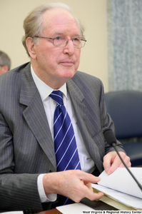 ["Chairman John D. (Jay) Rockefeller flips through some papers before a Commerce Committee hearing."]%