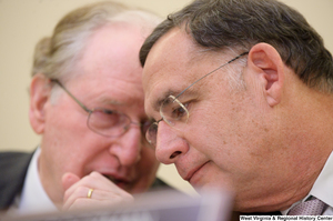 ["Senator John D. (Jay) Rockefeller whispers to Senator John Boozman during a Commerce Committee hearing."]%