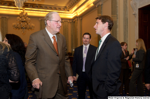 ["Senator John D. (Jay) Rockefeller talks with a young man at an event in the Senate."]%