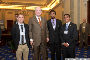 ["Senator John D. (Jay) Rockefeller stands next to three young men at a West Virginia Wednesday event."]%