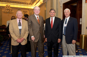 ["Senators John D. (Jay) Rockefeller and Joe Manchin stand with two men at a West Virginia Wednesday event in the Senate."]%