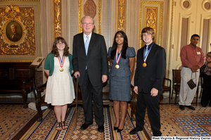 ["Senator John D. (Jay) Rockefeller stands with three West Virginia high school graduates who won the Presidential Scholars award."]%