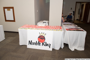 ["The Marble King company has a table at the 150th birthday celebration for West Virginia."]%