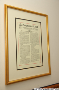 ["A framed Congressional Record where Senator John D. (Jay) Rockefeller celebrates the birth of his first grandchild hangs in his office."]%