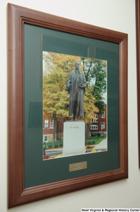 ["A framed photograph of a John Marshall statue hangs on a wall in Senator John D. (Jay) Rockefeller's office."]%