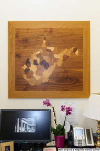 ["A wooden West Virginia hangs in Senator Rockefeller's office."]%