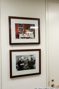 ["Two photos of Senator John D. (Jay) Rockefeller with West Virginians hang on the wall in his office."]%