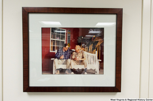 ["Senator John D. (Jay) Rockefeller sits on a white bench with an unidentified man."]%