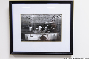 ["Senator John D. (Jay) Rockefeller sits in a coal car with some West Virginia miners."]%