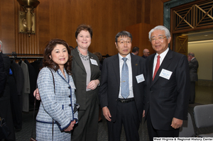 ["Four industry leaders stand together at a Welcome to Washington luncheon."]%