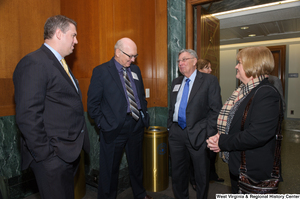 ["Four people talk at a Welcome to Washington luncheon."]%