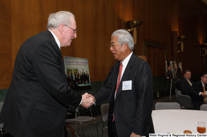 ["Senator John D. (Jay) Rockefeller shakes hands with an industry leader during a Welcome to Washington luncheon."]%