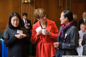 ["Three industry leaders talk during a Welcome to Washington luncheon."]%