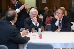 ["Three industry leaders sit at a table together at a Welcome to Washington luncheon."]%