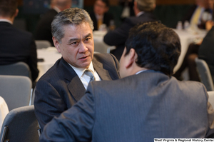 ["A business leader sits at the Welcome to Washington luncheon."]%