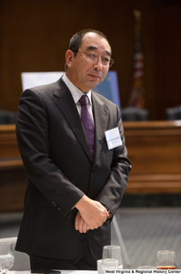 ["A business leader stands at the Welcome to Washington luncheon."]%