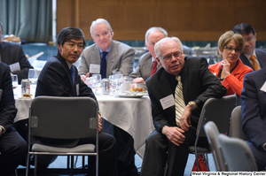 ["Several business leaders sit around a table at the Welcome to Washington luncheon."]%