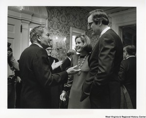 ["Newly appointed Governor Jay Rockefeller and Sharon Rockefeller talking to his uncle, David Rockefeller, at the Governors Reception after the Inauguration ceremonies."]%