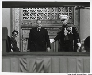 ["David Rockefeller, Governor Jay Rockefellers uncle, being escorted to the dais shortly before the inauguration."]%