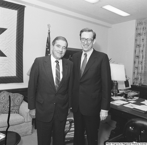 ["Senator John D. (Jay) Rockefeller stands with an unidentified man for a photograph in his office."]%