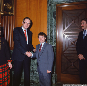 ["Senator John D. (Jay) Rockefeller greets an unidentified individual following the Senate Swearing-In Ceremony."]%