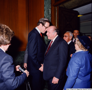 ["Senator John D. (Jay) Rockefeller shakes the hand of an unidentified individual at the Senate Swearing-In Ceremony."]%
