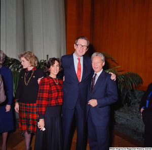 ["Two unidentified individuals pose for a photograph with Senator John D. (Jay) Rockefeller at his Senate Swearing-In Ceremony."]%