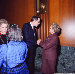 ["Senator John D. (Jay) Rockefeller and his wife Sharon greet and shake hands with two supporters at the Senate Swearing-In Ceremony."]%