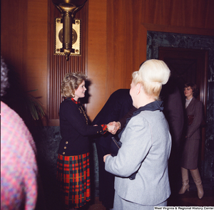 ["Sharon Rockefeller shakes hands with supporters at her husband's Senate Swearing-In Ceremony."]%