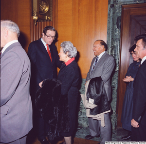 ["Senator John D. (Jay) Rockefeller greets smiling unidentified supporters after he is sworn into office."]%
