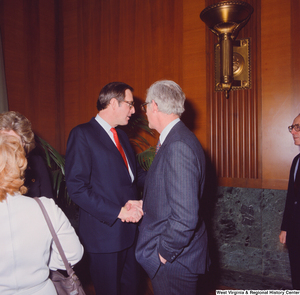 ["Senator John D. (Jay) Rockefeller shakes hands with an unidentified supporter at the Senate Swearing-In Ceremony."]%