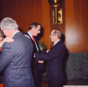 ["An unidentified supporter shakes hands with Senator John D. (Jay) Rockefeller at the Senate Swearing-In Ceremony."]%
