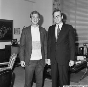 ["Senator John D. (Jay) Rockefeller and an unidentified man stand for a photograph in the Senator's office."]%