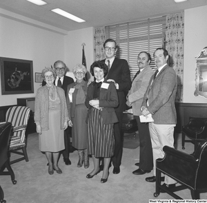 ["Senator John D. (Jay) Rockefeller stands for a photograph in his office with a group of West Virginia School Board officials."]%