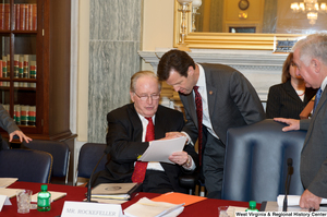 ["Senator John D. (Jay) Rockefeller shakes hands with a man before a Commerce Committee hearing."]%