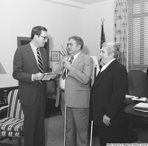 ["Senator John D. (Jay) Rockefeller speaks with two individuals from the West Virginia Chapter of the National Federation of the Blind."]%