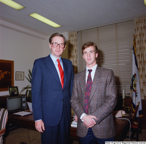 ["This color photograph shows Senator John D. (Jay) Rockefeller standing with an unidentified young man in his office."]%