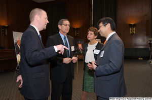 ["Industry leaders talk to one another at a Welcome to Washington luncheon."]%