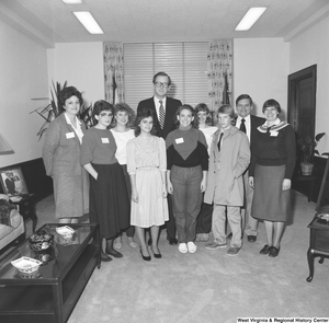 ["Senator John D. (Jay) Rockefeller poses for a photograph with a group of unidentified student visitors."]%