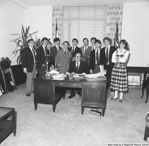 ["Senator John D. (Jay) Rockefeller is photographed in his office with an unidentified group of student visitors."]%