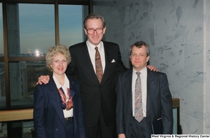 ["Senator John D. (Jay) Rockefeller stands with two unidentified individuals."]%