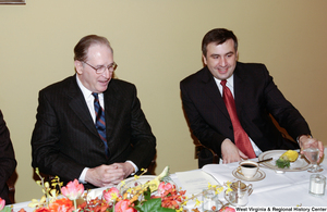 ["Senator John D. (Jay) Rockefeller sits next to an unidentified man at a luncheon at the Senate."]%