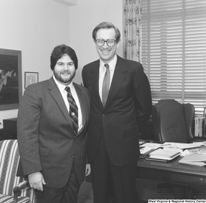 ["Senator John D. (Jay) Rockefeller stands with a man from National Home Study in his office."]%