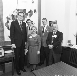 ["Senator John D. (Jay) Rockefeller stands for a photograph with a representative from Wheeling's Oglebay Resort and three other unidentified individuals in his Washington office."]%