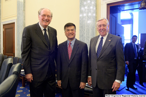 ["Senator John D. (Jay) Rockefeller and Congressman Steny Hoyer stand beside an unidentified man outside the Commerce Committee hearing room."]%